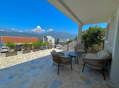 a patio with a table and chairs on a balcony at Villa Regulus in Tivat