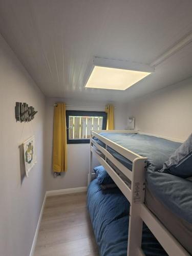 a bedroom with a bunk bed and a window at Moira Garden Tiny Home in Moira
