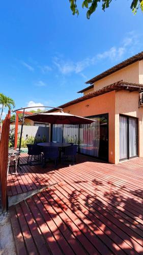 a patio with a table and an umbrella at Fontes da Pipa by Liiv in Pipa