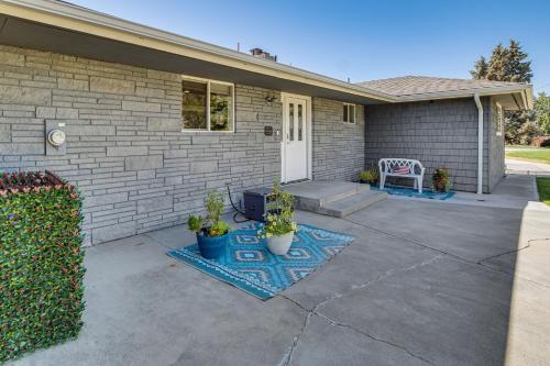 a house with a patio with a white door at Fish, Swim, Relax Moses Lake Gem with Outdoor Oasis in Moses Lake