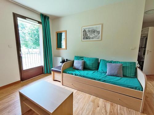 a living room with a couch and a table at La Bicyclette, T2, wifi, parking, balcon, 4 personnes in Luchon