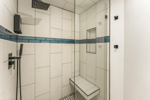 a bathroom with a shower with a bench in it at Iconic Vail Dome Unit 2 in Vail