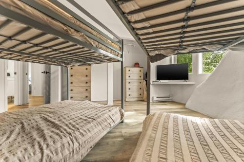 a bedroom with two beds and a flat screen tv at Iconic Vail Dome Unit 2 in Vail