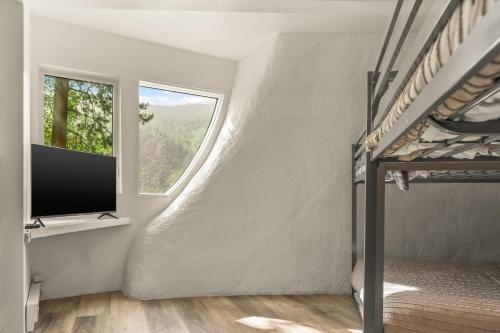 a living room with a staircase and a window at Iconic Vail Dome Unit 2 in Vail
