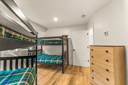 a bedroom with two bunk beds and a dresser at Iconic Vail Dome Unit 2 in Vail