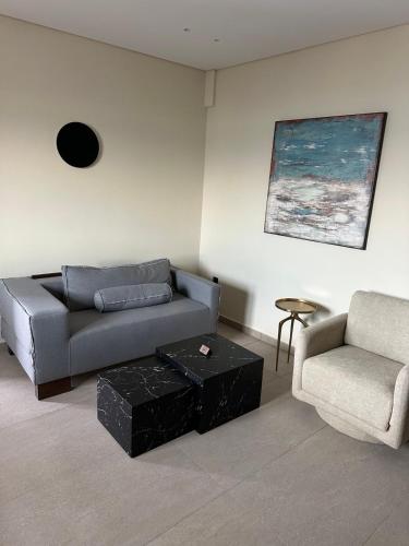 a living room with a couch and a chair at La vie luxury suites in Megalochori
