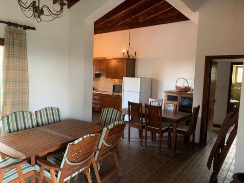 a kitchen and dining room with a wooden table and chairs at Mountain View! Cosy life in Nicosia