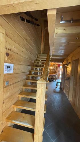 a staircase in a cabin with a wooden ceiling at Chalet Capilou linga 4 étoiles in Châtel