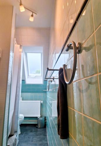 a bathroom with a towel rack on the wall at Alter Mühlenhof in Nordenham