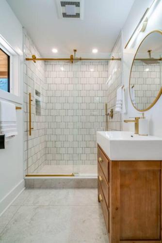 a bathroom with a sink and a shower with a mirror at New Paltz Modern Zen Cabin in New Paltz