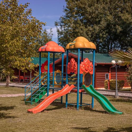 a playground with two slides in a park at Kompleksi Turistik Leonardo in Shëngjin