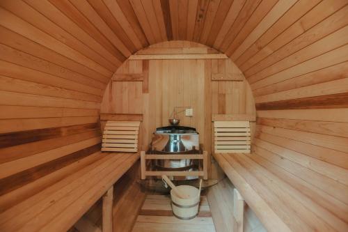 an inside of a sauna with a stove in it at NASU terrace MANA 森のバレルサウナとBBQグリル in Nasu