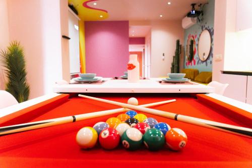 a pool table with balls and cuesticks on it at Capsule Girl Power SPA - balneo - Sauna - Karaoké - Billard - 2 chambres in Charleroi
