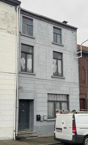a white van parked in front of a building at Capsule Girl Power SPA - balneo - Sauna - Karaoké - Billard - 2 chambres in Charleroi