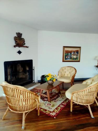 a living room with two chairs and a fireplace at Hotel Luxor in Ouro Preto