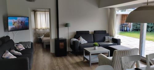 a living room with a couch and a table at Sterrenhemel in Kamperland