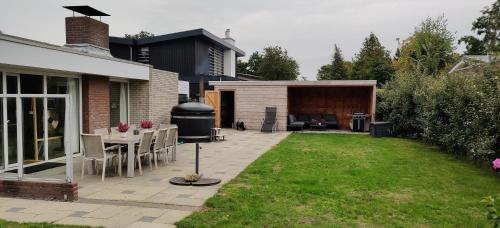 a backyard with a grill and a table and chairs at Sterrenhemel in Kamperland
