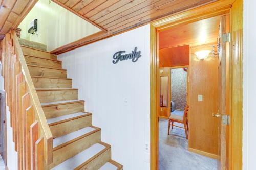 a staircase in a house with a sign on the wall at 6 Mi to Grandfather Mtn Peaceful Getaway with Grill in Newland