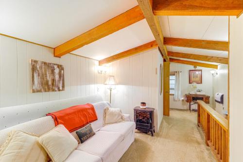 a living room with a white couch and a table at 6 Mi to Grandfather Mtn Peaceful Getaway with Grill in Newland