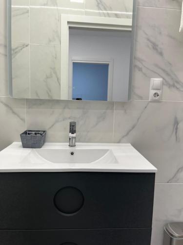 a bathroom with a sink and a mirror at Villa Amir in Fuengirola