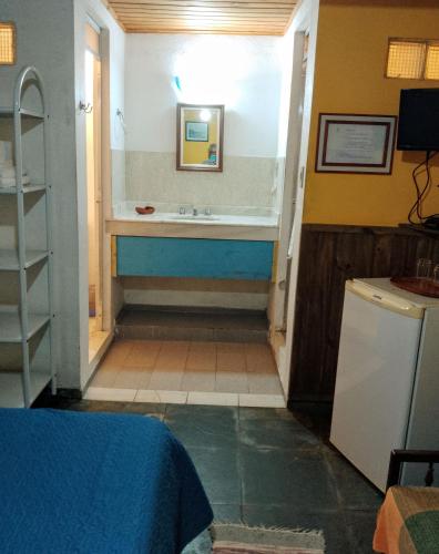 a bathroom with a bath tub and a sink at Pousada Arboretum in Penedo