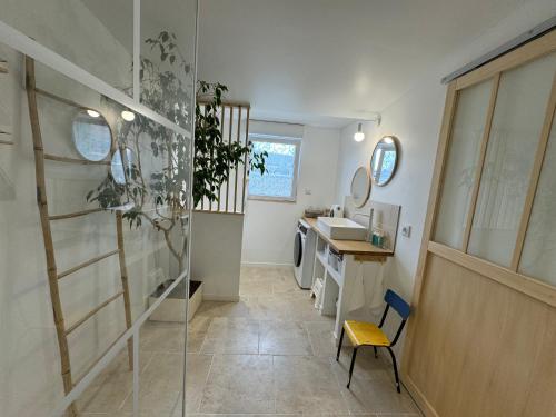 a bathroom with a glass shower and a sink at Le Gite de l Ancre in Ville-sur-Ancre