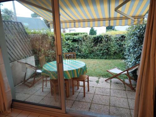 une terrasse avec une table et des chaises ainsi qu'une tente dans l'établissement Studio jardin 300 m plage, à Carnac