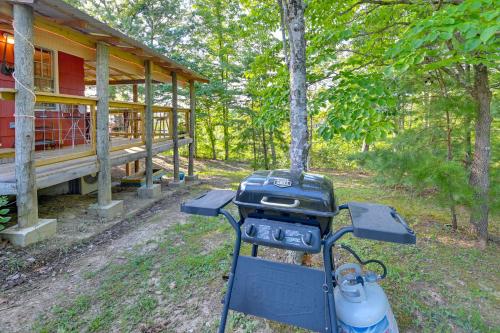 a gas grill in front of a house at Cozy Beattyville Cabin with Fire Pit and Hot Tub in Beattyville