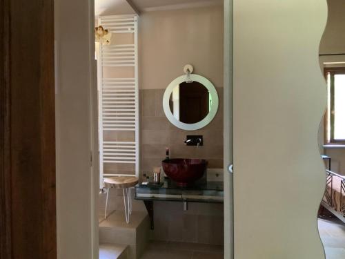 a bathroom with a sink and a mirror at B&B Le Piote in Alessandria