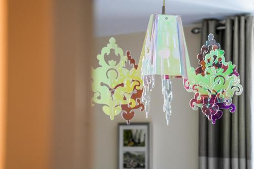a chandelier hanging from a ceiling in a room at Logis Hôtel & Restaurant Le Cadet de Gascogne in Saint-Justin