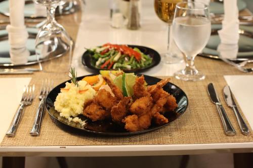 a table with two plates of food on a table at Hotel Agualcas in Managua