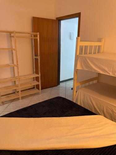 a room with two bunk beds and a doorway at RESIDENCIAL PORTAL DO SOL in Bombinhas