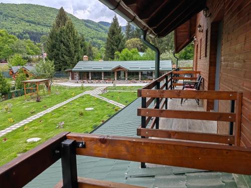a porch of a building with a bench on it at Pensiunea Pastravaria Vistisoara in Vistisoara