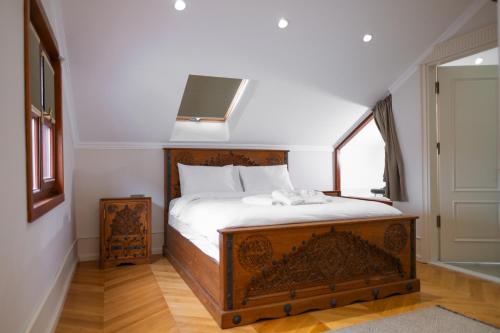 a bedroom with a wooden bed with a window at Koçin Konak Luxury Boutique Home in Soğuksu