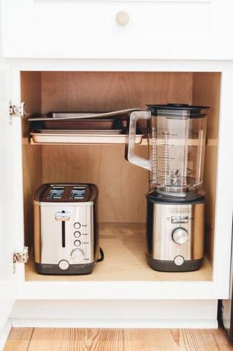 a blender and a toaster are sitting on a shelf at NEW! 1937 Coastal Cottage by Beach, Boardwalk, & Lake! in Carolina Beach