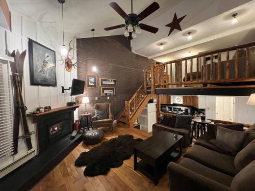 a living room with a couch and a fireplace at Ski In, Ski Out Cozy Creek Side Cabin w Front Yard in Steamboat Springs