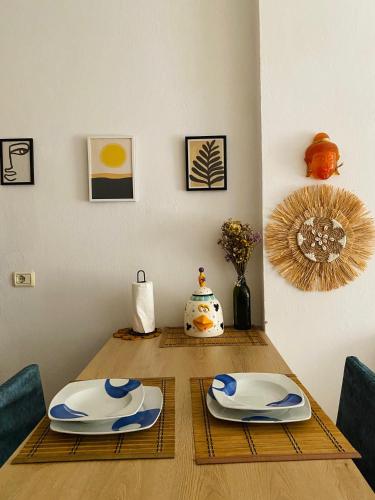 a dining room table with two plates on it at Sea La Vie in Golem