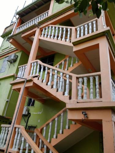 a building with wooden stairs on the side of it at Chaleanor Hotel in Dangriga