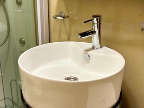 a white sink in a bathroom with a shower at Villa Sveti Stefan in Budva