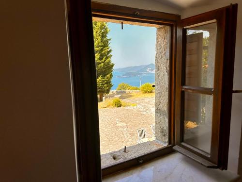 an open window with a view of the ocean at Villa Sveti Stefan in Budva