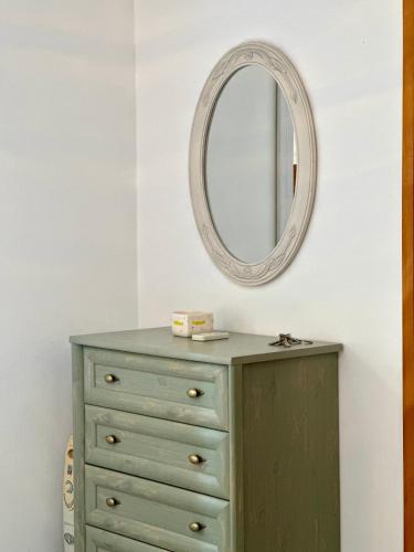 a green dresser with a mirror on a wall at Villa Sveti Stefan in Budva