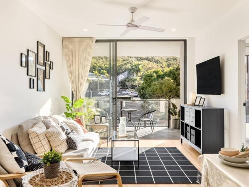 a living room with a couch and a table at Stunning Mount View Modern Apartment MtGravatt CBD in Brisbane