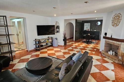 a living room with a couch and a table at Apartment in big house with private pool & large outdoor space in L'Alfas del Pi