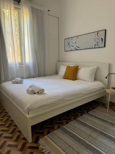 a large white bed in a room with a window at Maze Apartments - Perfectly located brand new flats in Tel Aviv