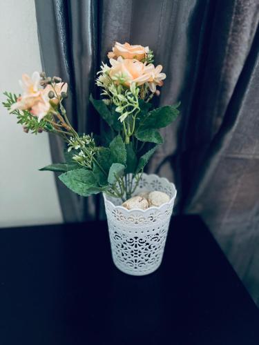 a vase with flowers in it sitting on a table at Golden Glory Manor in Roodepoort