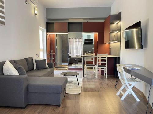 a living room with a couch and a table at Central Charming Studio Old Town in Durrës