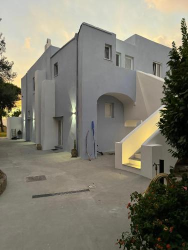 a white building with stairs in front of it at Il Carrubo in Procida