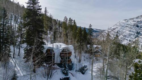 a house is covered in snow on a mountain at Iconic Vail Dome Unit 2 in Vail