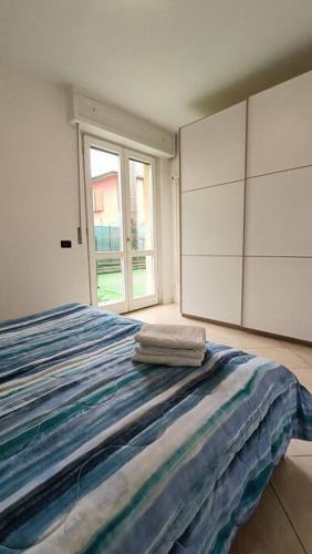 a bedroom with a bed with two towels on it at Aeroporto & Fiera 30 in Seriate
