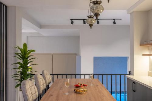a dining room with a wooden table and chairs at Villa cihan kalkan in Kas